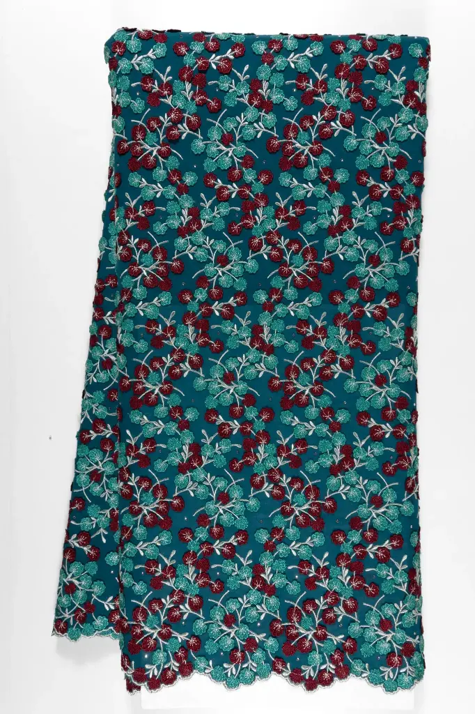 Embroidered allover with sewed on motifs