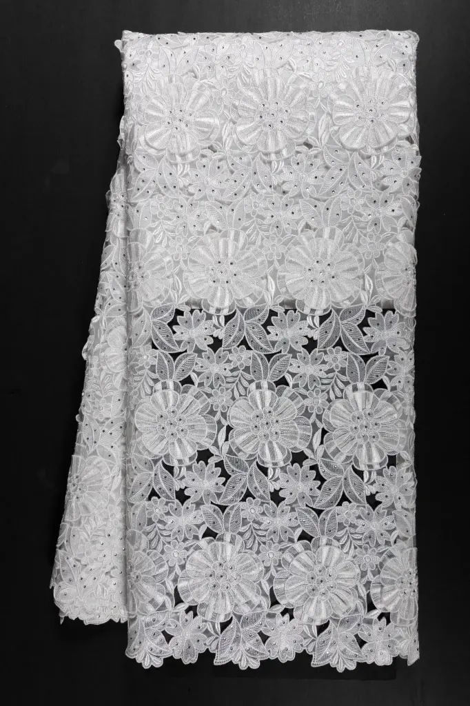 Embroidered allover with sewed on motifs 