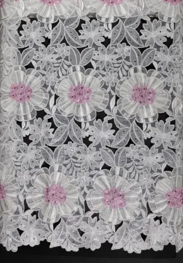 Embroidered allover with sewed on motifs 